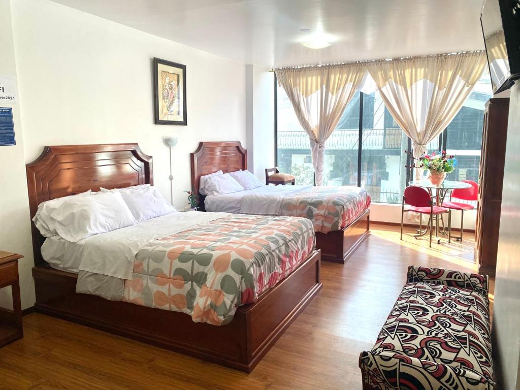Postel nebo postele na pokoji v ubytování Loreto hotel