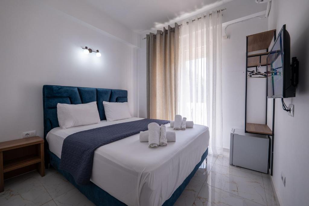Postel nebo postele na pokoji v ubytování Hotel Elite Sarande