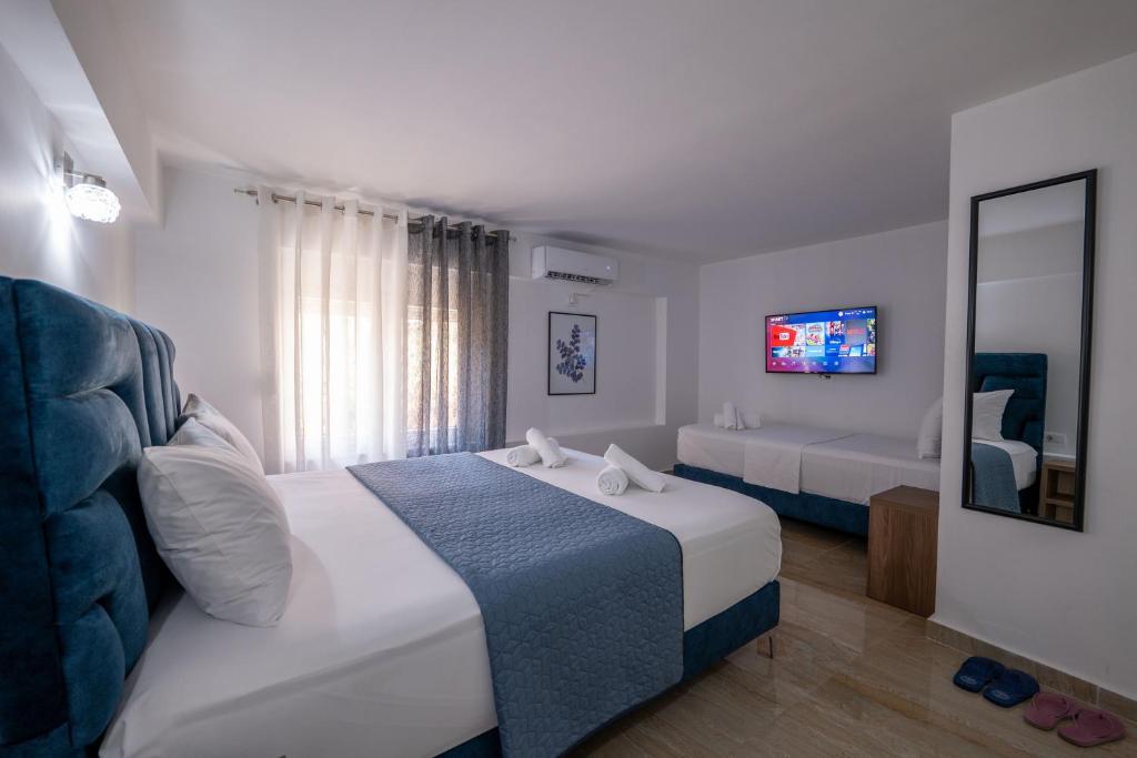 Postel nebo postele na pokoji v ubytování Hotel Elite Sarande