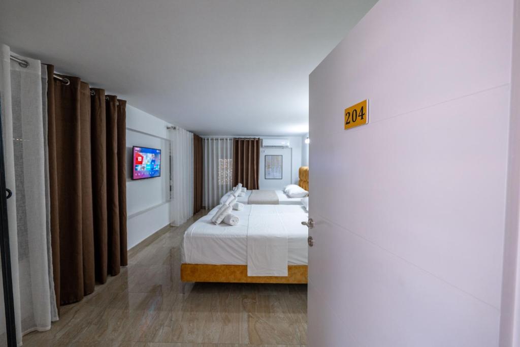 Postel nebo postele na pokoji v ubytování Hotel Elite Sarande