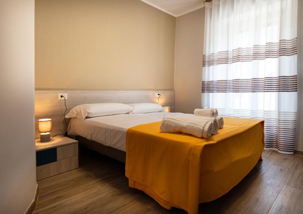 Postel nebo postele na pokoji v ubytování Nella mia città