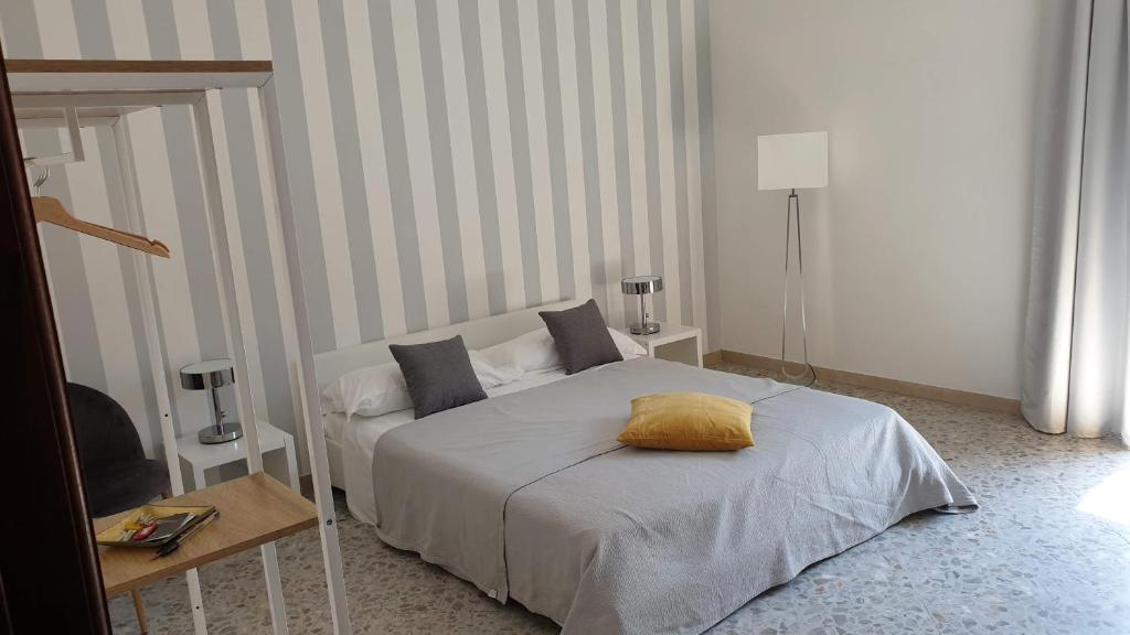 a bedroom with a bed with a yellow pillow on it at sorrento joy in Sorrento