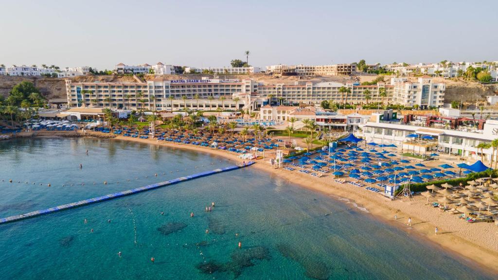 an aerial view of a beach with chairs and umbrellas at Marina Sharm Hotel in Sharm El Sheikh