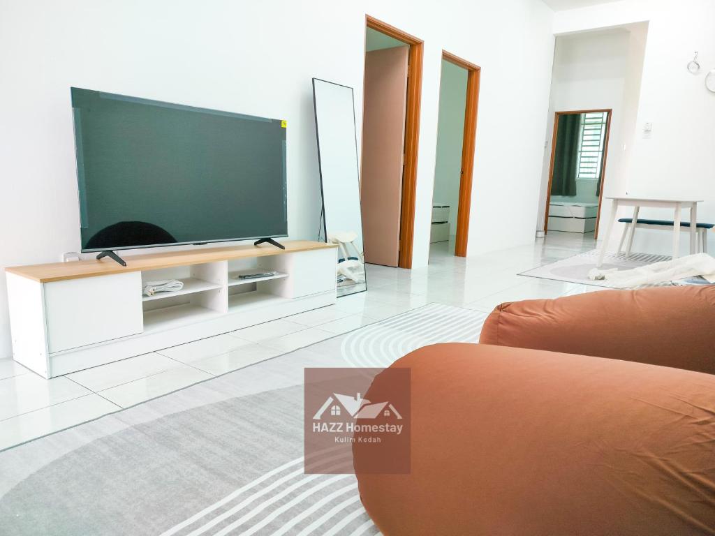 a living room with a large flat screen tv at HAZZ Homestay Puncak Ihsan in Kulim