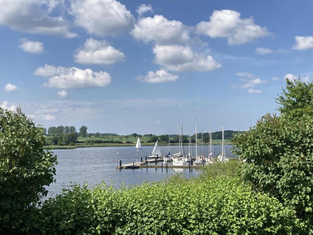 a dock with sailboats on a lake with clouds in the sky at Kieholm in Bohnert