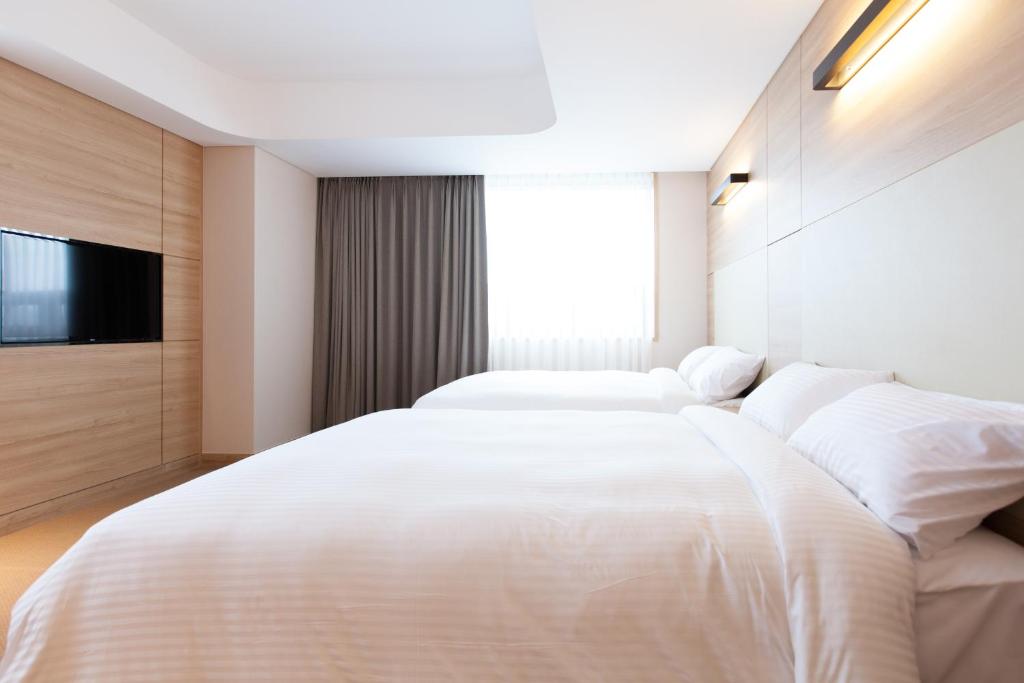 Postel nebo postele na pokoji v ubytování Acube Hotel Dongdaemun