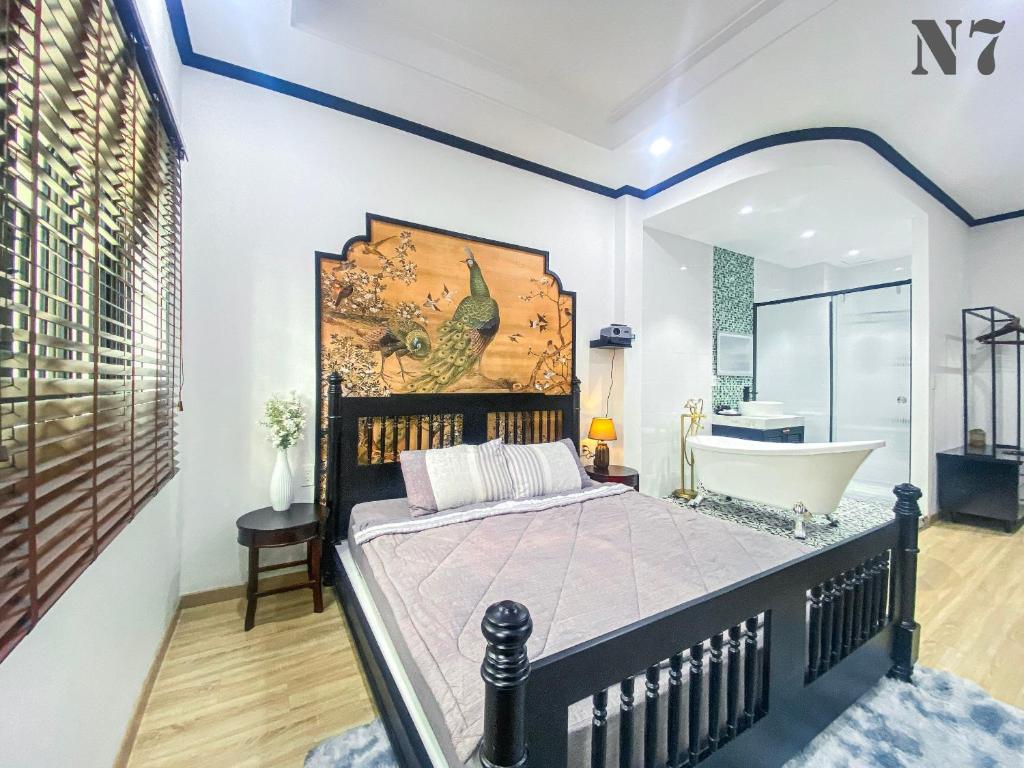 a bedroom with a bed and a bath tub at H'homestay quận 1 - N7 in Ho Chi Minh City