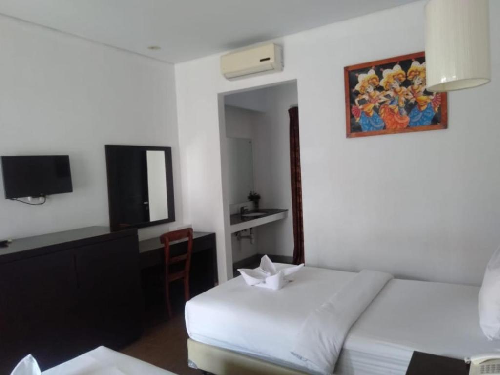 Postel nebo postele na pokoji v ubytování Hotel Ompu Herti