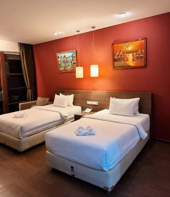 Postel nebo postele na pokoji v ubytování Hotel Ompu Herti