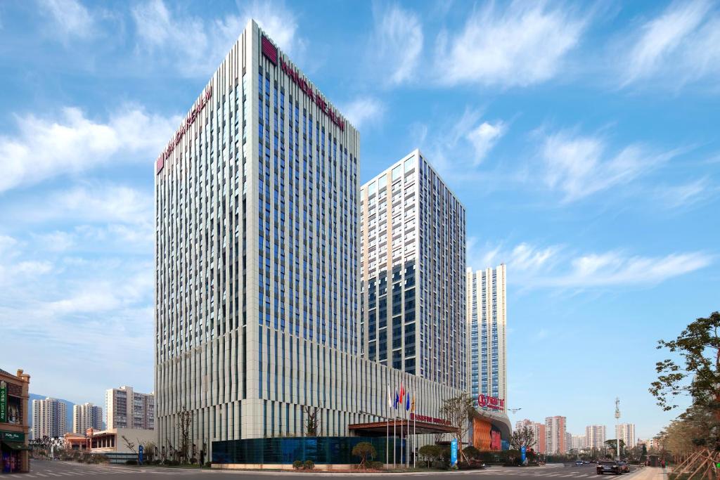 a tall building with two towers in a city at Wanda Realm Guangyuan in Guangyuan