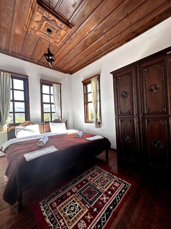a bedroom with a large bed and a wooden ceiling at Ecevit Hanı in Küre