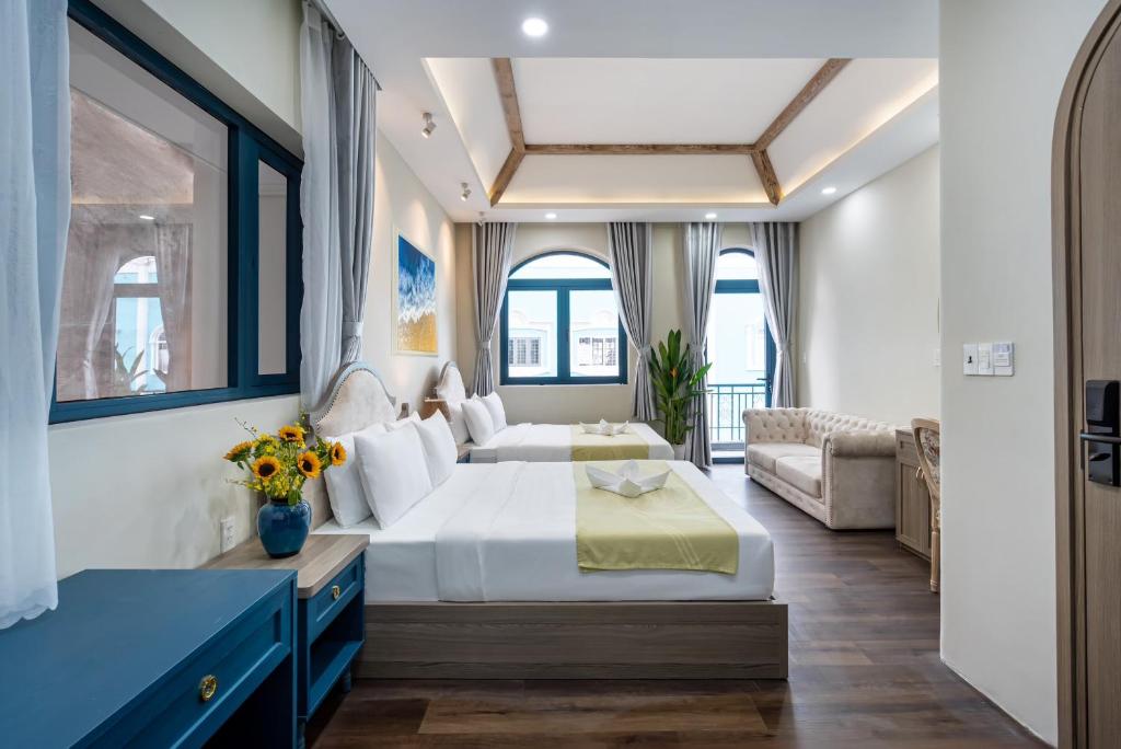 a hotel room with a bed and a couch at Jan Villa SaiGon Oasis in Ho Chi Minh City