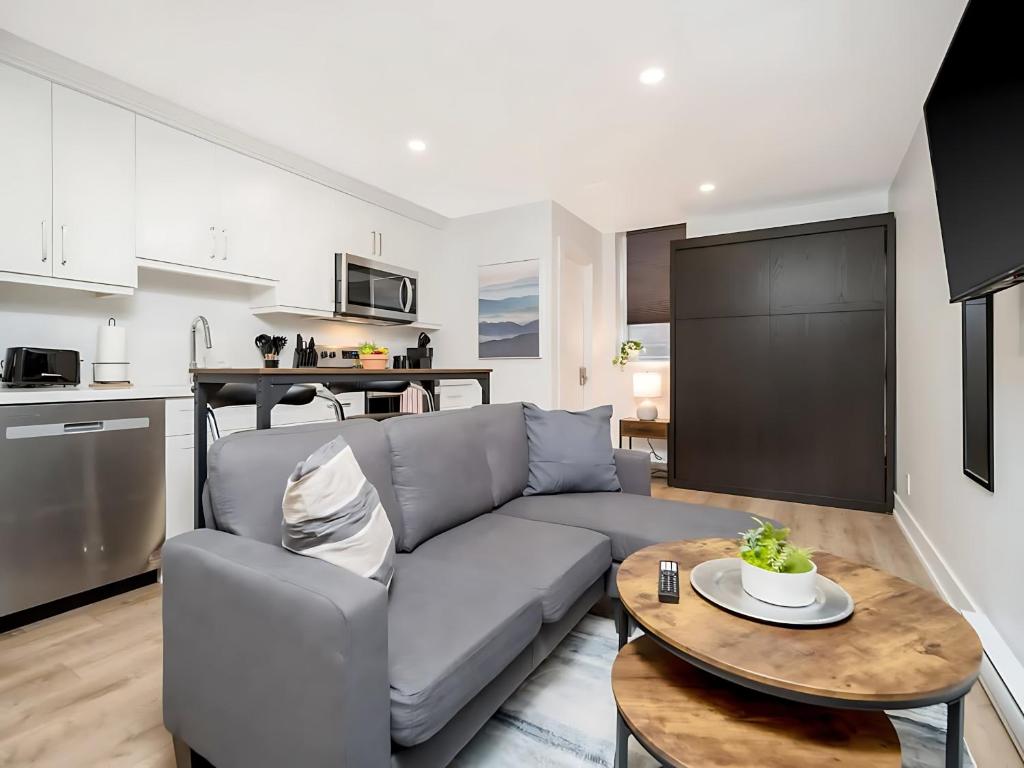 a living room with a couch and a table at Cozy Studio Apt - Corktown Hamilton in Hamilton