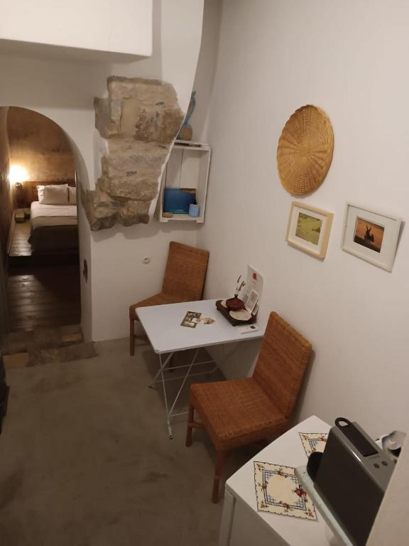 a room with a table and chairs and a bed at Latmos 1860 in Skala