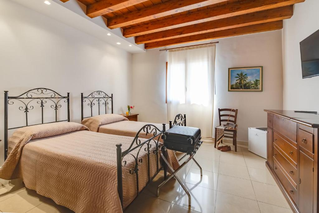 Postel nebo postele na pokoji v ubytování Hotel Aliai