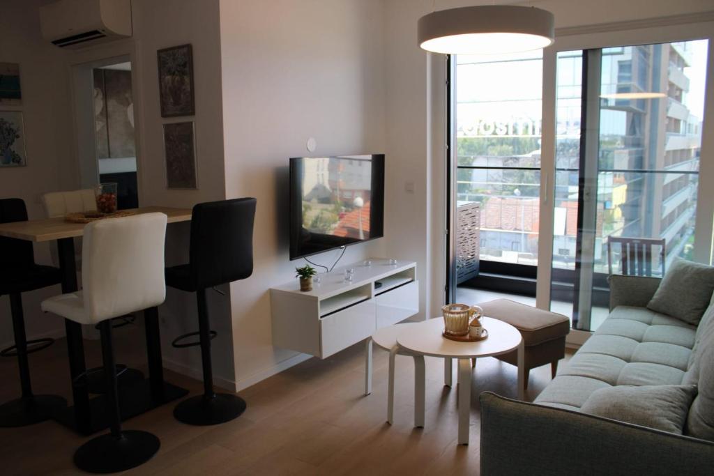 a living room with a couch and a tv at Bubi Apartments-Private parking in Zagreb