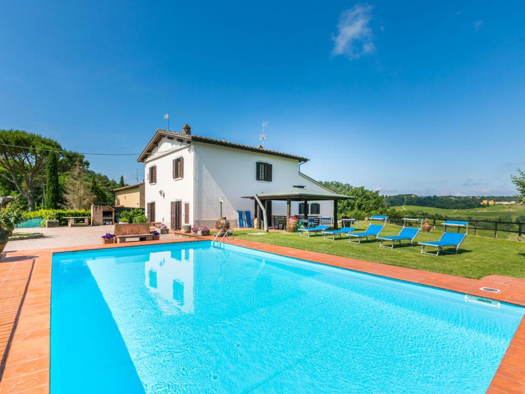 a large swimming pool in front of a house at Holiday Home Il Poggetto by Interhome in Mercatale Val Di Pesa