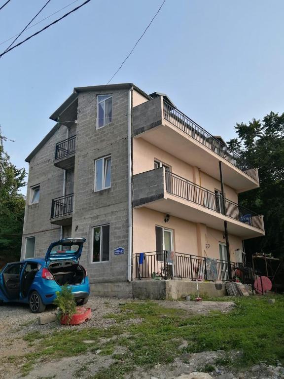 a house with a car parked in front of it at Golden Heart in Batumi