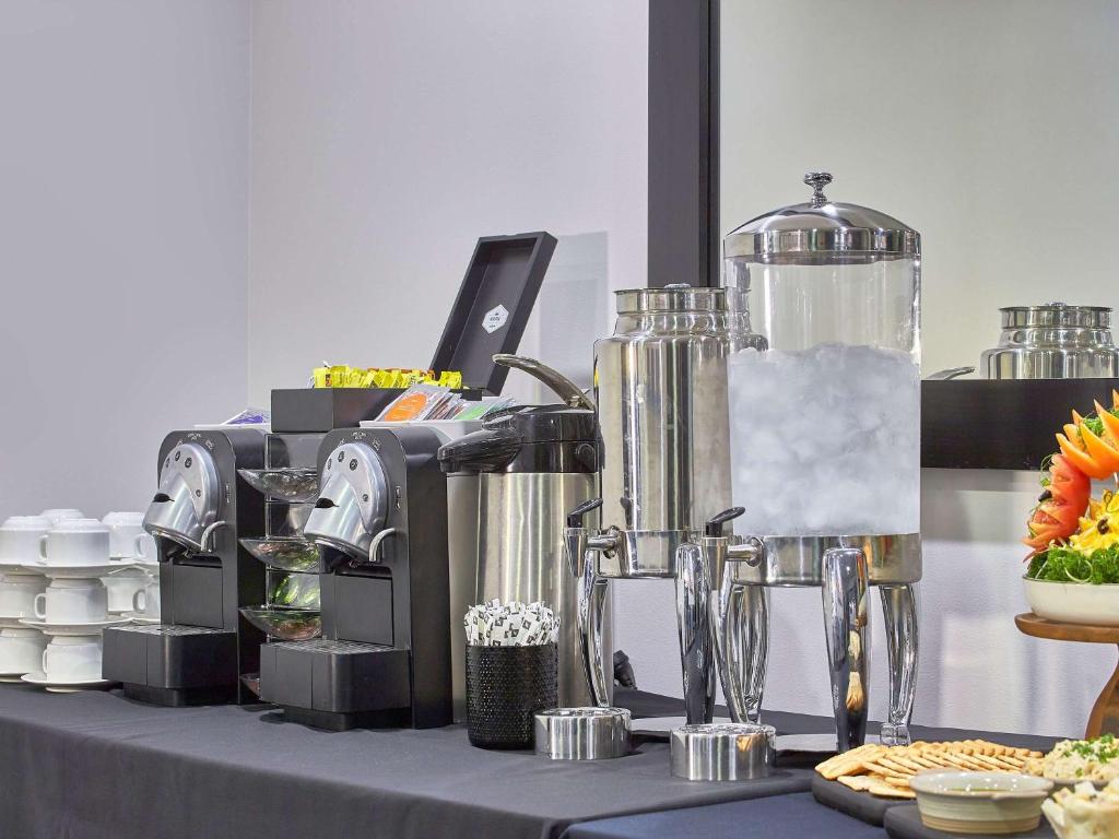 a table topped with silver equipment on top at Mercure Melbourne Southbank in Melbourne