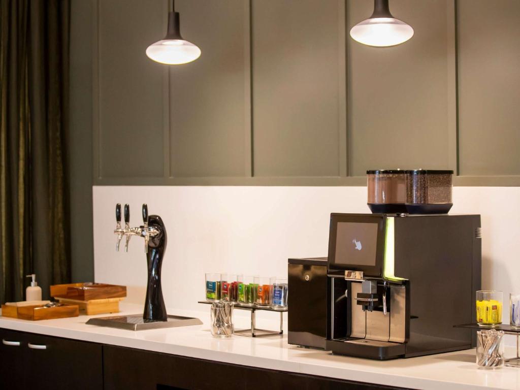 a counter with a coffee maker on top of it at Mercure Melbourne Southbank in Melbourne