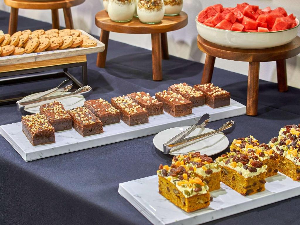 a table with a bunch of different types of desserts at Mercure Melbourne Southbank in Melbourne