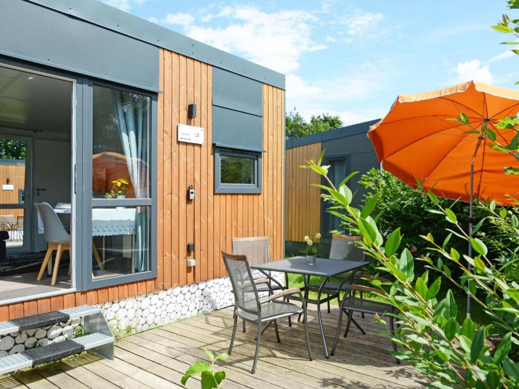 Un patio con una mesa y sillas y una sombrilla. en Holiday Home Tiny Haus Conny by Interhome, en Beilngries