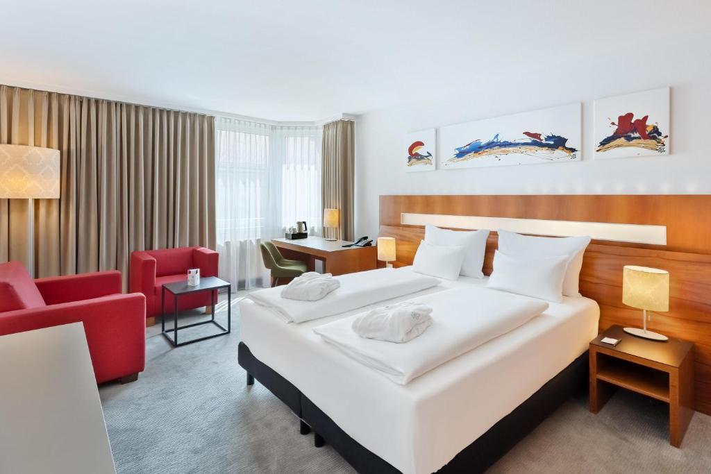 Una cama o camas en una habitación de Austria Trend Hotel Europa Graz Hauptbahnhof