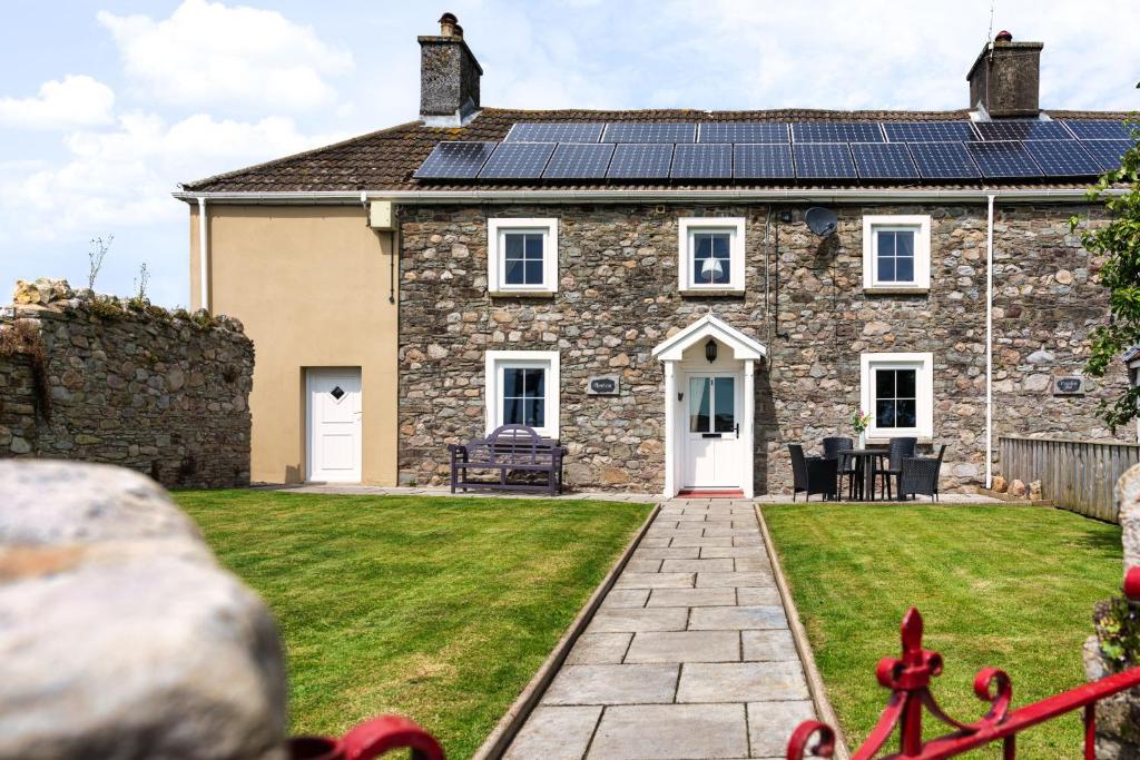 a house with solar panels on the roof at Hawton in Kidwelly