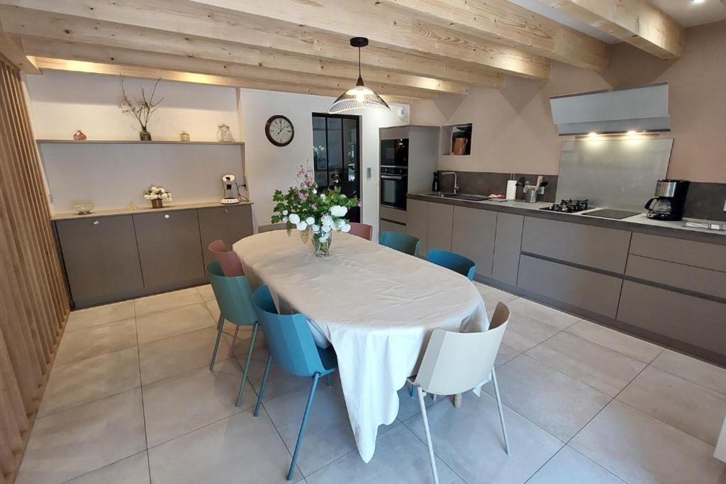 a kitchen with a table and chairs in a room at Gite 8 personnes Ussel Grande Maison rénovée in Ussel