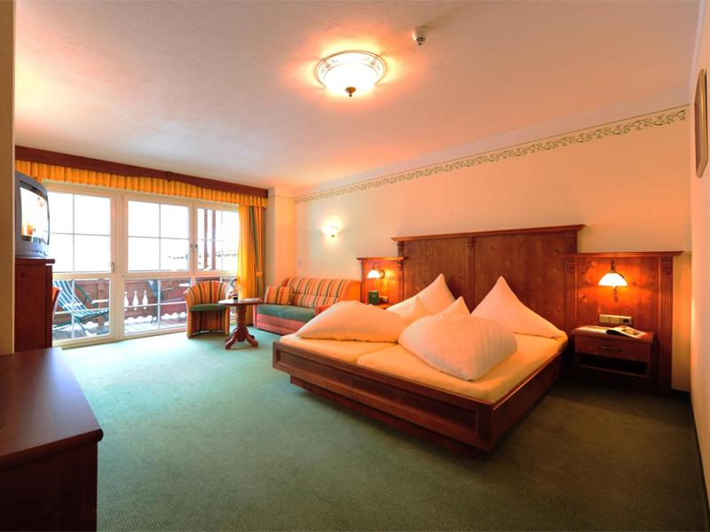 Postel nebo postele na pokoji v ubytování Hotel Dorfstadl