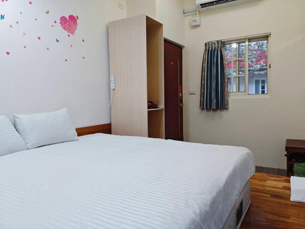 Postel nebo postele na pokoji v ubytování Sanyi Dream Garden B&B