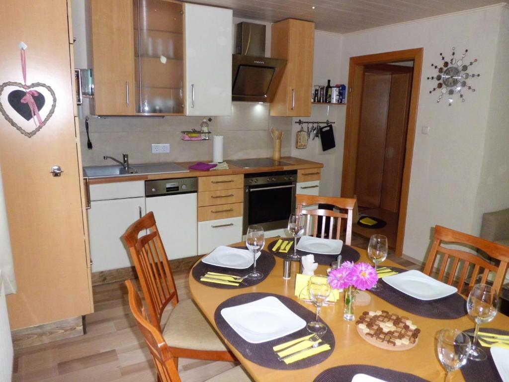 a kitchen with a table with chairs and a dining room at Haus Marina Apartment Alpenrose mit Gratis Eintritt Alpentherme in Bad Hofgastein