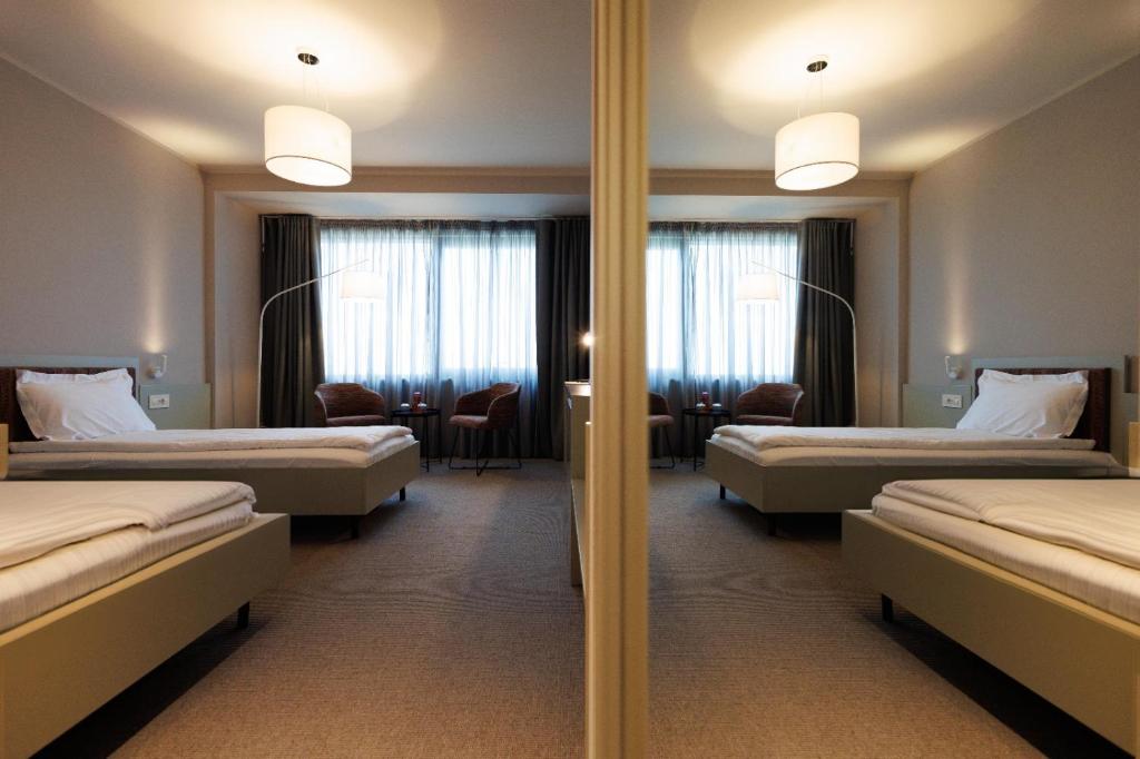 Postel nebo postele na pokoji v ubytování Millennium Hub & Hotel