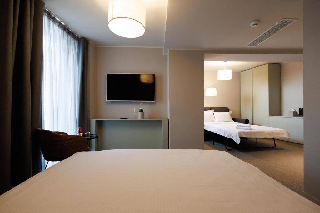Postel nebo postele na pokoji v ubytování Millennium Hub & Hotel