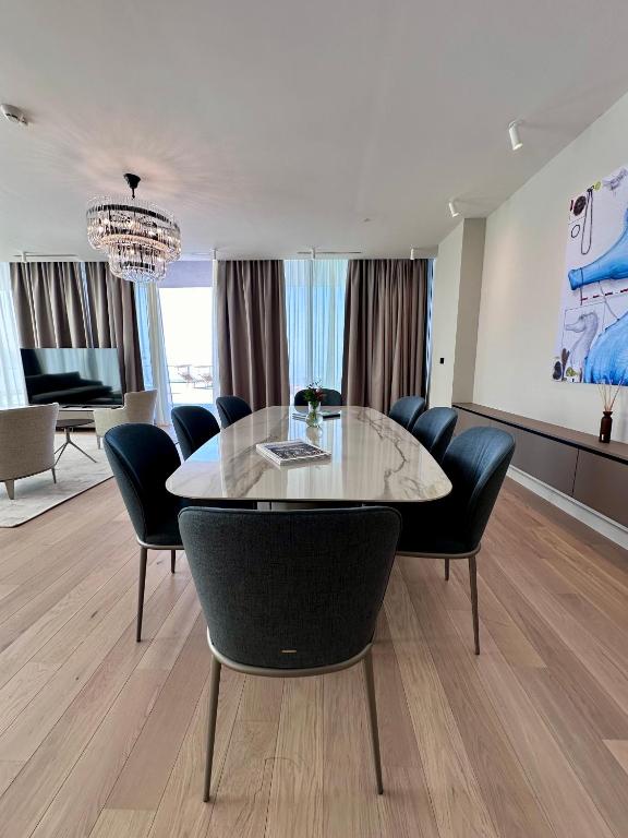 a dining room with a table and chairs at Sea Star Budva in Budva