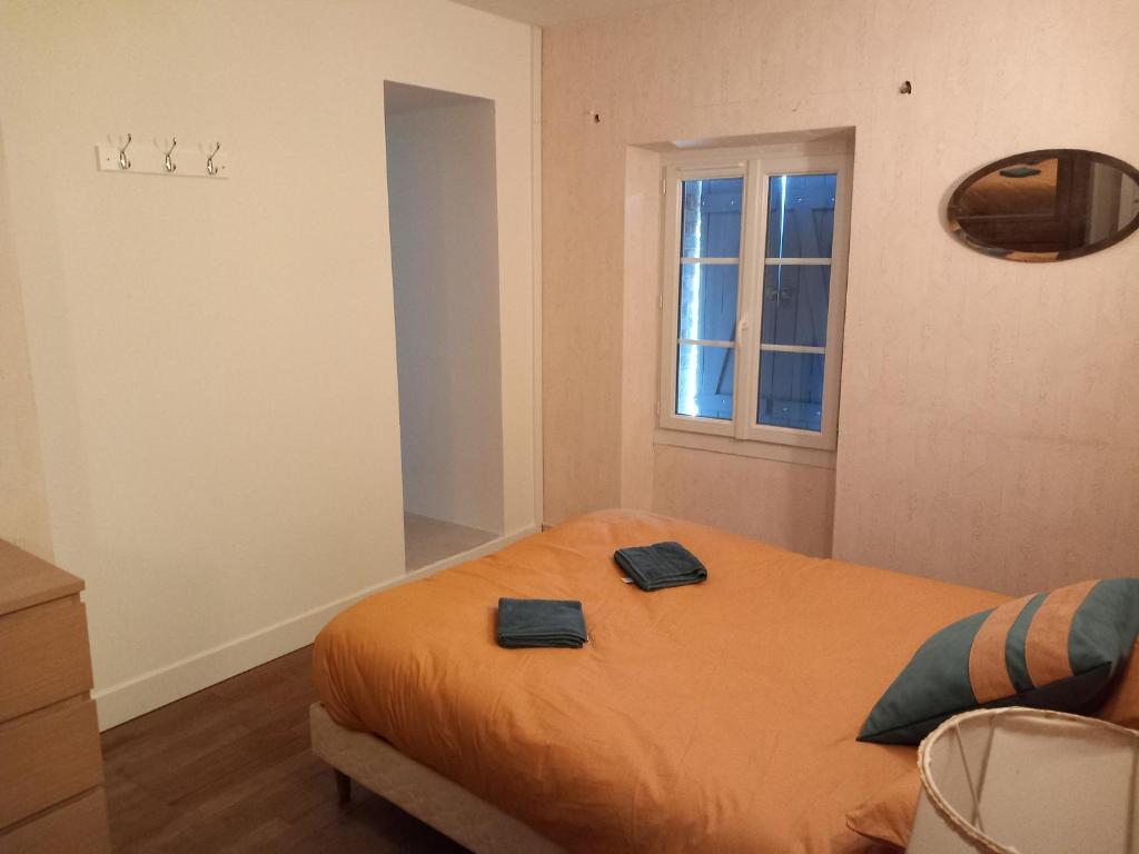 a bedroom with a bed with two towels on it at Via Lactéa in Saint-Goussaud