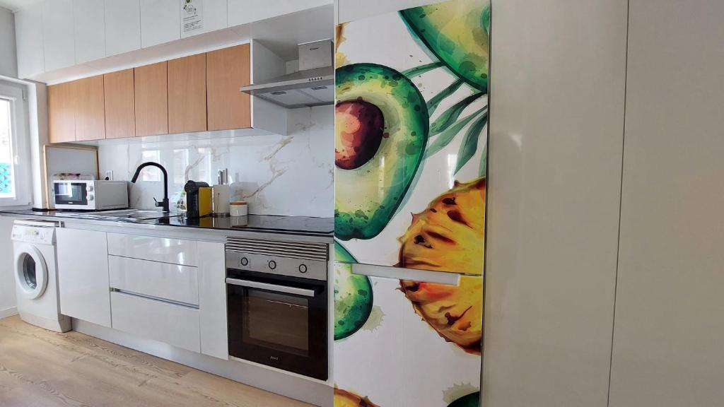 a kitchen with a painting of donuts on the wall at Ericeira TOP in Ericeira
