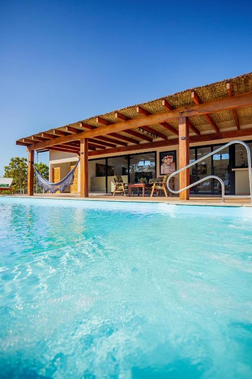 a view of a swimming pool with a house at CasaAnacã Ecolounge in Bonito