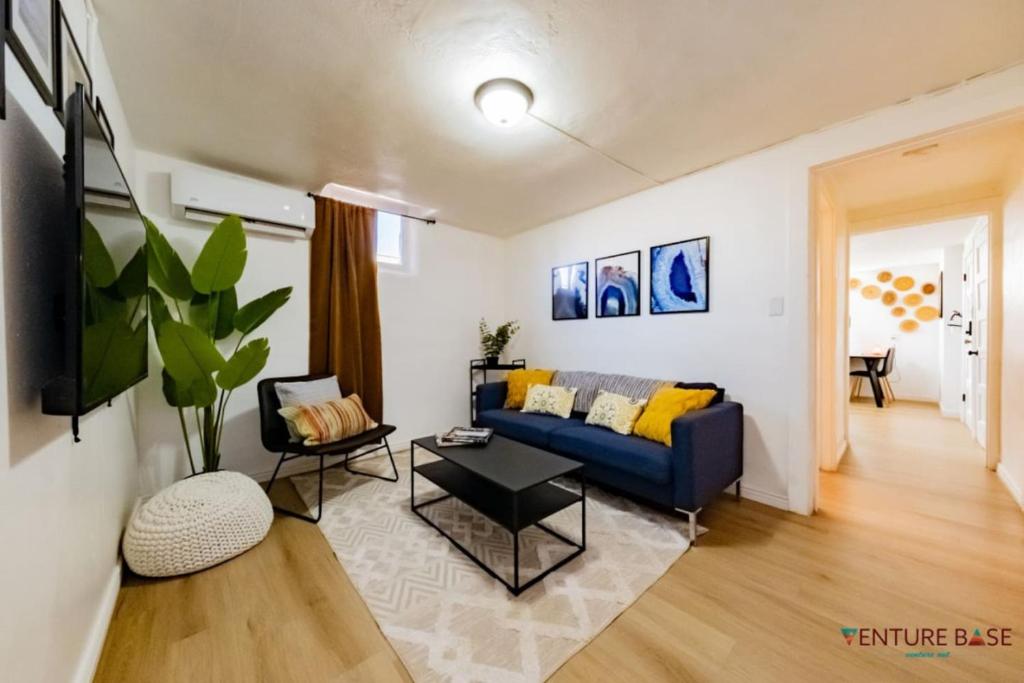a living room with a blue couch and a table at Adventure's Oasis, Venture Base Unit 4 in Kanab