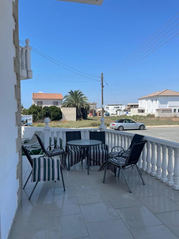 a patio with chairs and a table on a balcony at Valentine Family Villa in Kiti