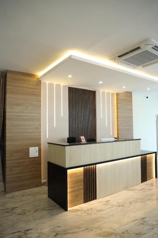 a lobby with a reception desk in a building at VR PARADISE Inn in Kelambākkam