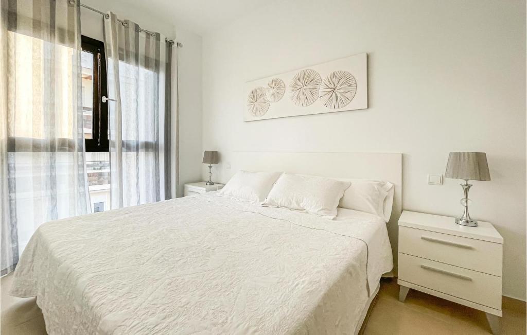 A bed or beds in a room at Awesome Apartment In Estepona With Wifi