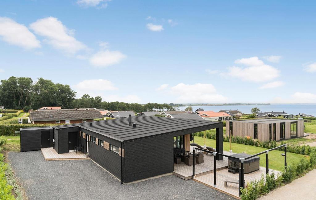 a black house with a black roof at 3 Bedroom Lovely Home In Sjølund in Sjølund