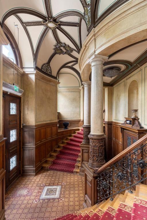 an ornate hallway with a staircase in a building at The Benjamin House in Rīga