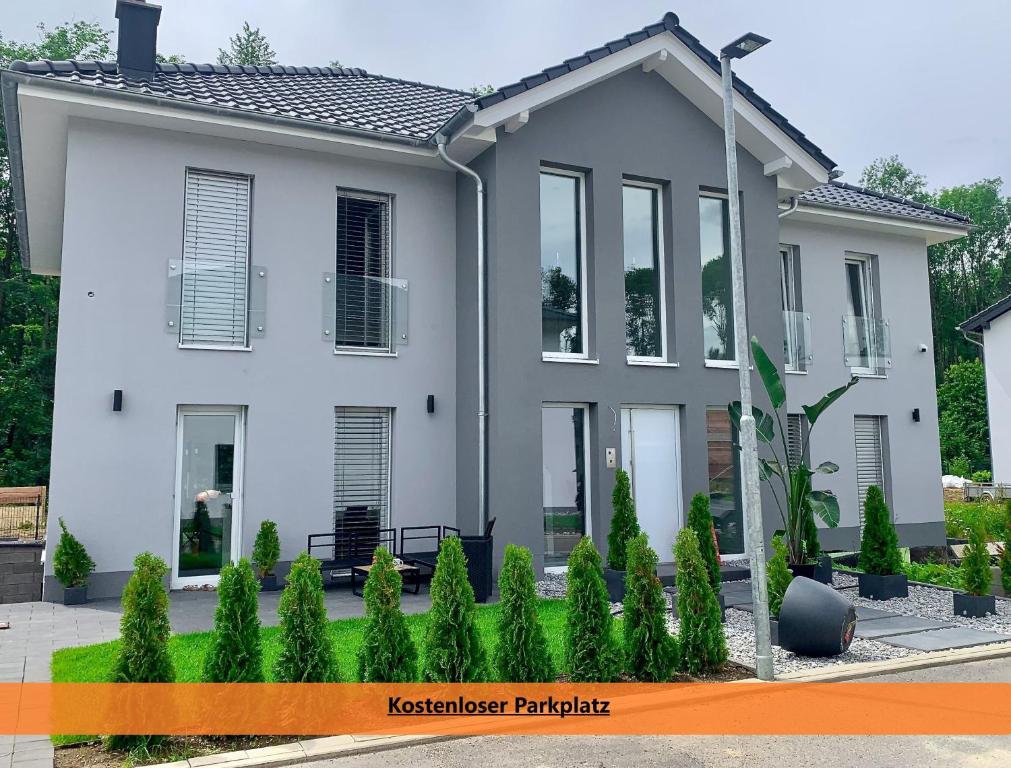 a white house with a lot of windows at Better Living-Exklusive Ferienwohnung 76qmTerrasse in Montabaur