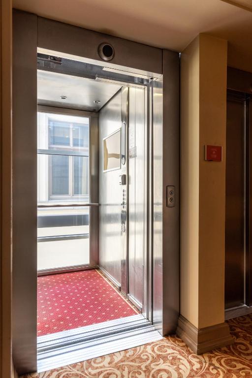 a glass door in a room with a window at The Benjamin House in Rīga
