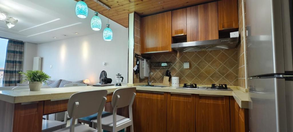 Kuchyň nebo kuchyňský kout v ubytování Chaoyang Joy City Hardcover Apartment