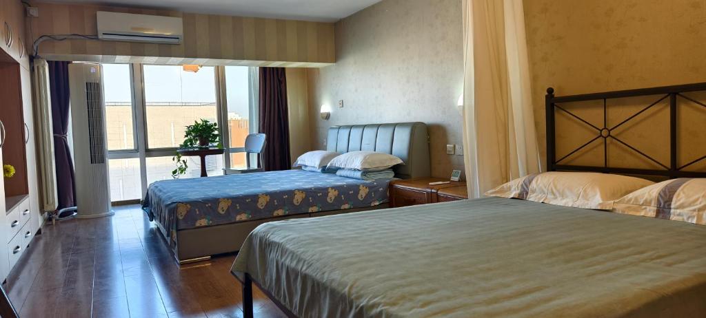 Postel nebo postele na pokoji v ubytování Chaoyang Joy City Hardcover Apartment