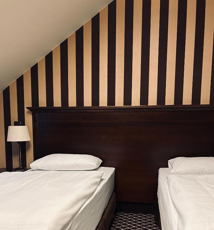 Postel nebo postele na pokoji v ubytování Hotel Wileński