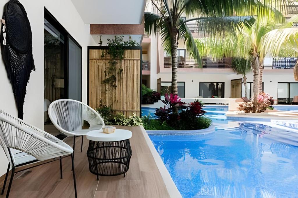 Bazén v ubytování Casa de lujo Ka'an Maya acceso SwimUp a la piscina nebo v jeho okolí